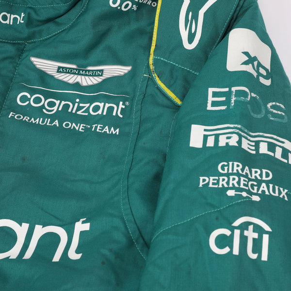 Close-up of the fabric and stitching on Fernando Alonso’s 2023 F1 racing suit, capturing the high-quality material and detailed sponsor branding, designed for durability and race-ready functionality.