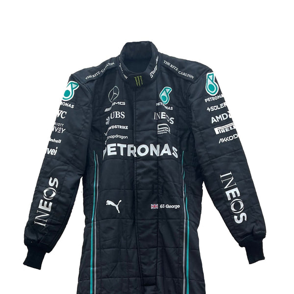 Close-up of the fabric and stitching on George Russell’s 2023 racing suit, revealing the intricate details and high-quality materials, with clear visibility of sponsor logos.