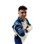 Close-up of Isack Hadjar's 2025 F1 race suit, displaying the intricate white fabric with blue and green accents and detailed sponsor logos.