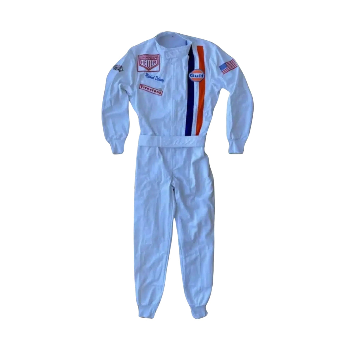 Front view of Michael Delaney’s 1971 Le Mans racing suit worn by Steve McQueen, featuring off-white base, vertical Gulf racing stripes in blue and orange, and vintage patchwork detailing. Main image